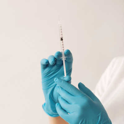 Doctor holding up a needle for botox and fillers