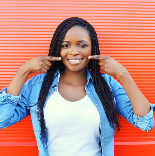 Woman pointing to her new smile